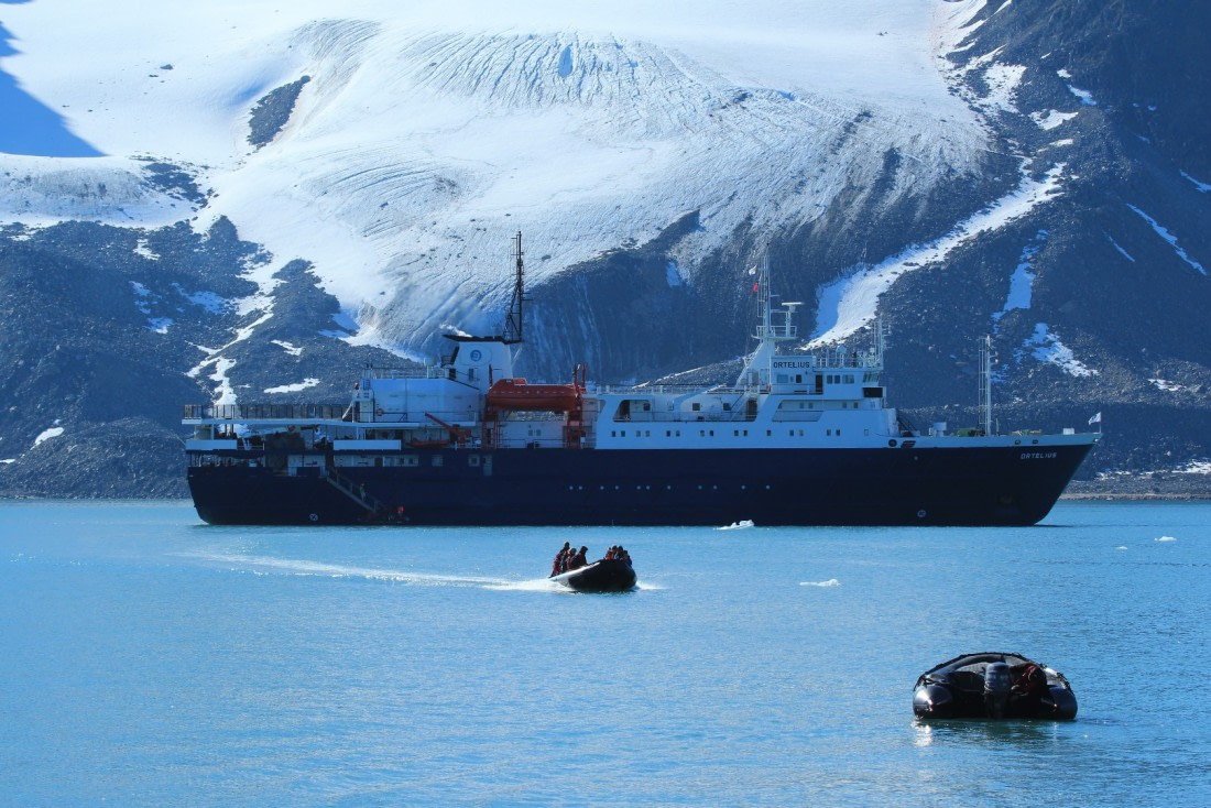 Zodiacs cruising to the landing site with the MV Ortelius in the back laying in front of the Tindebreen