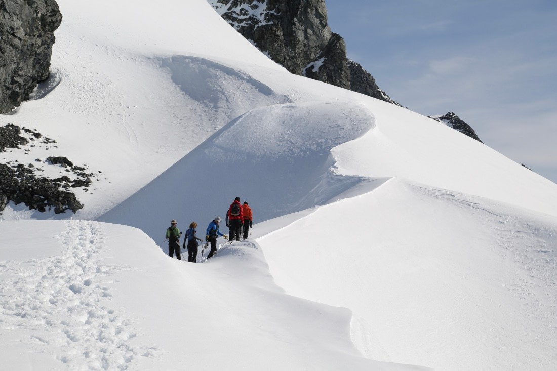 Mountaineers approaching a ridge