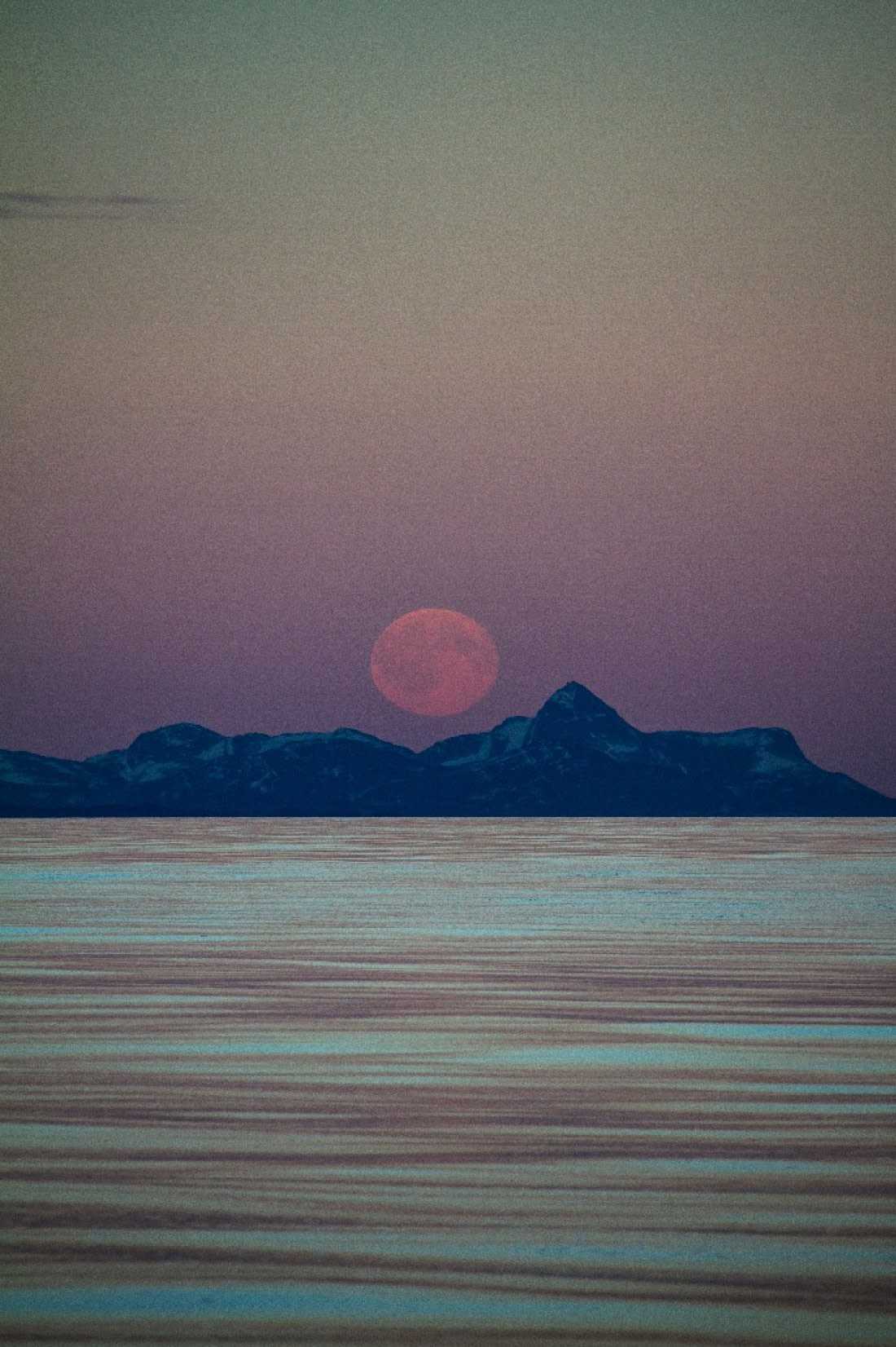 moon rise with the colors of the midnight sun
