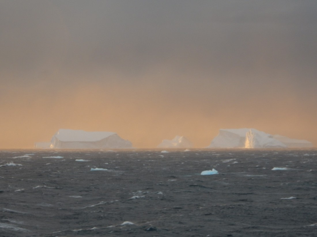 Icebergs on fire during sunset.