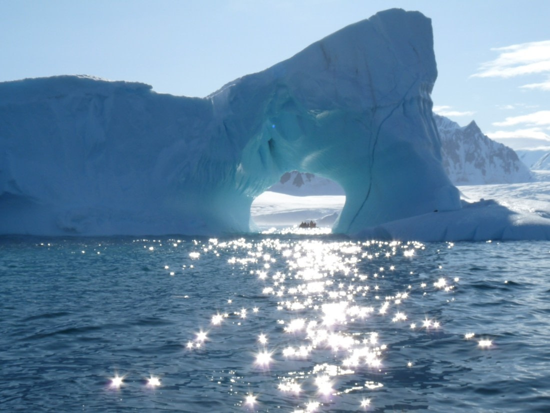 Zodiac cruising through iceberg hole