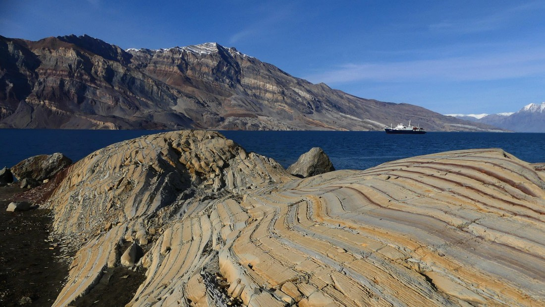 PLA11-24, Day 8,  Stripey yellow rocks with Plancius 2 16 x 9 © John Rogers - Oceanwide Expeditions.JPG