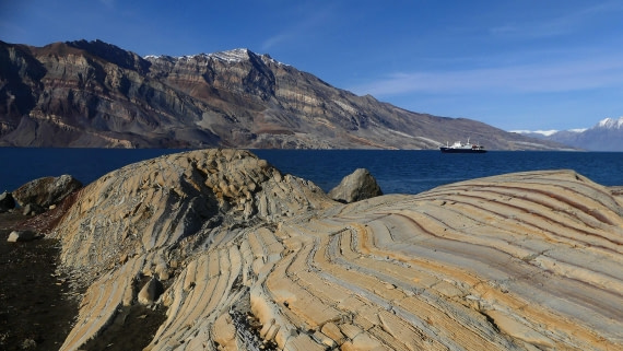 PLA11-24, Day 8,  Stripey yellow rocks with Plancius 2 16 x 9 © John Rogers - Oceanwide Expeditions.JPG